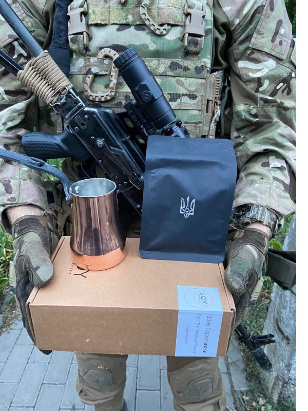 ukrainian soldier holding a coffee in action care package