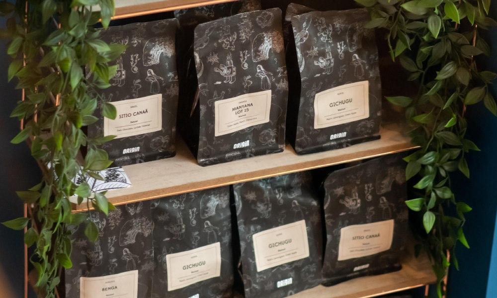 bags of coffee on a wooden shelf sourced from a wholesale coffee roaster